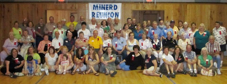 100th anniversary Minerd Reunion. I am seated on the floor near the middle in a gray dress. My stepmother Sharon is to the right in a black top and jeans. My stepsister Lisa is to my left in a purple top.